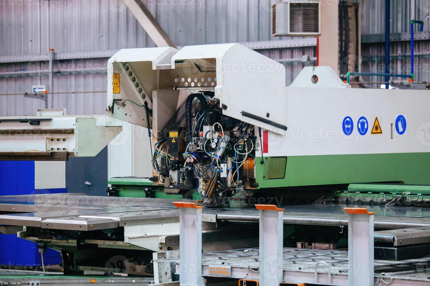 Modern CNC perforation machine in metalworking factory photo