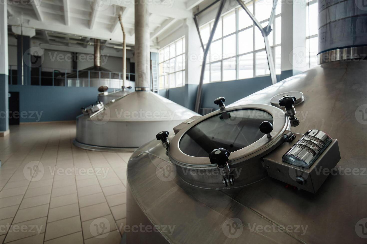 Looking glass of steel tank for beer fermentation in modern brewery photo