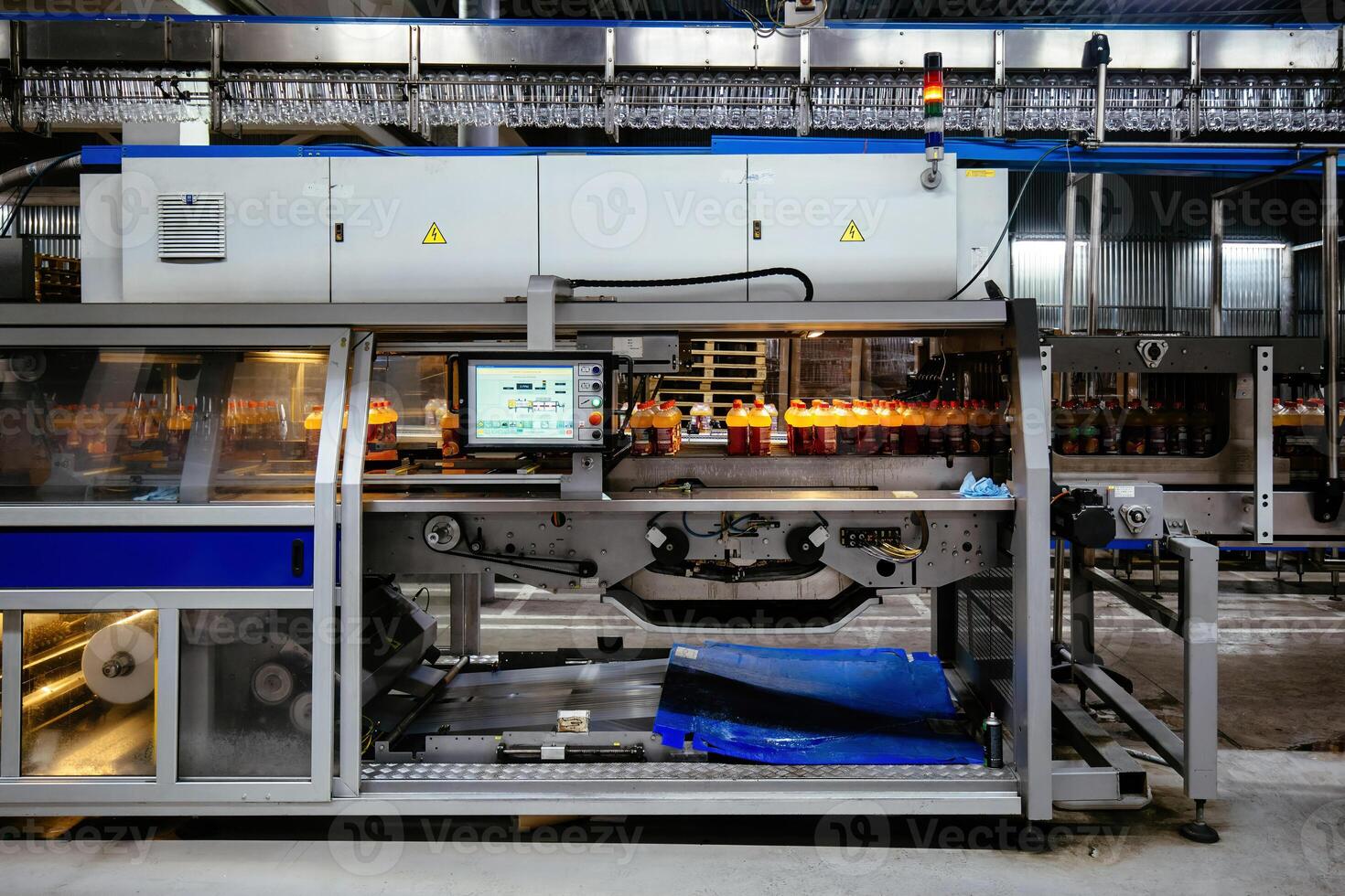 Modern automated production line of bottling of beverage into plastic bottles photo