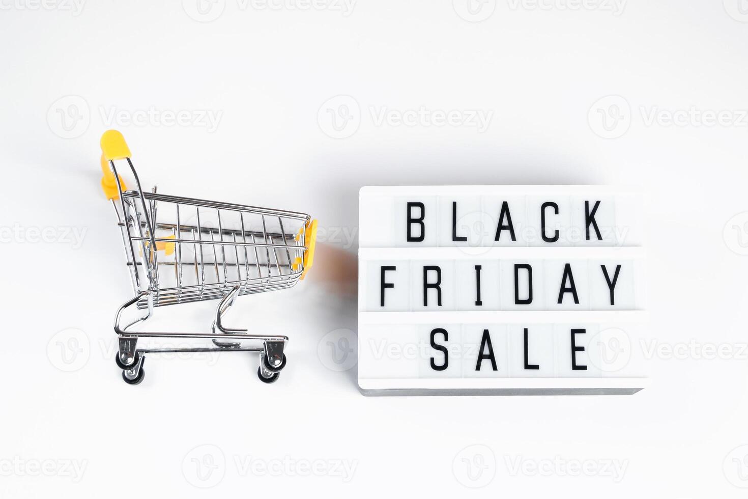 Sale and Black Friday concept. Mini shopping cart on white background. photo