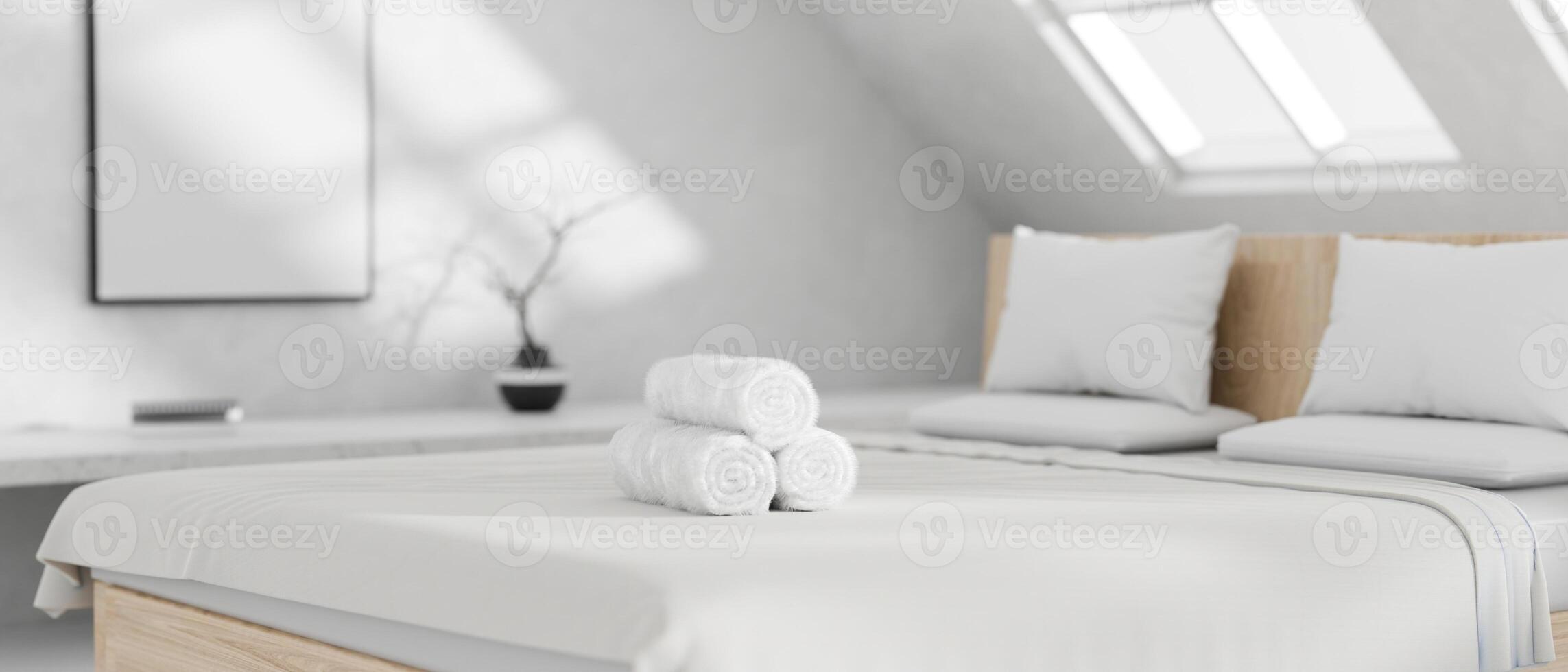 Close-up of white towels on a white bed in a minimalist white bedroom. A minimalist neat hotel room. photo