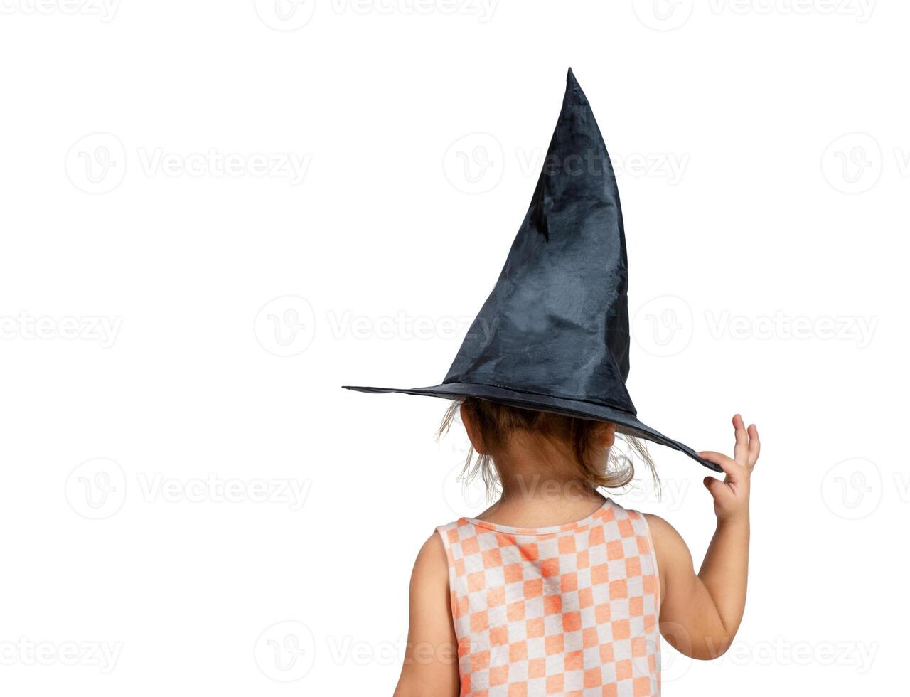 Girl holding witch hat back view isolated photo