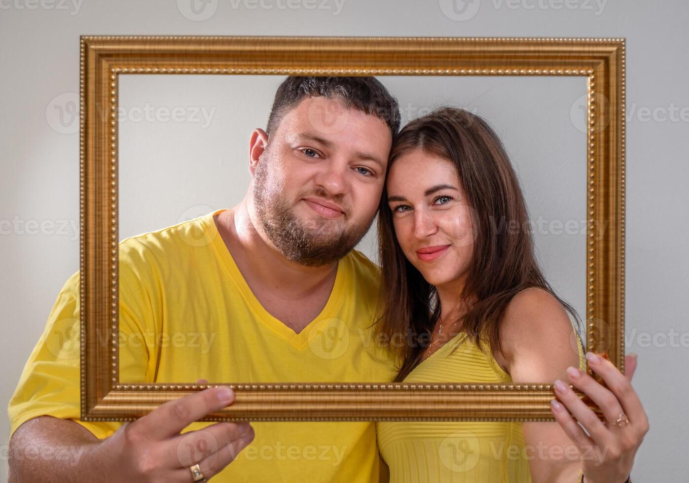 Portrait of a couple in yellow clothes in a frame photo