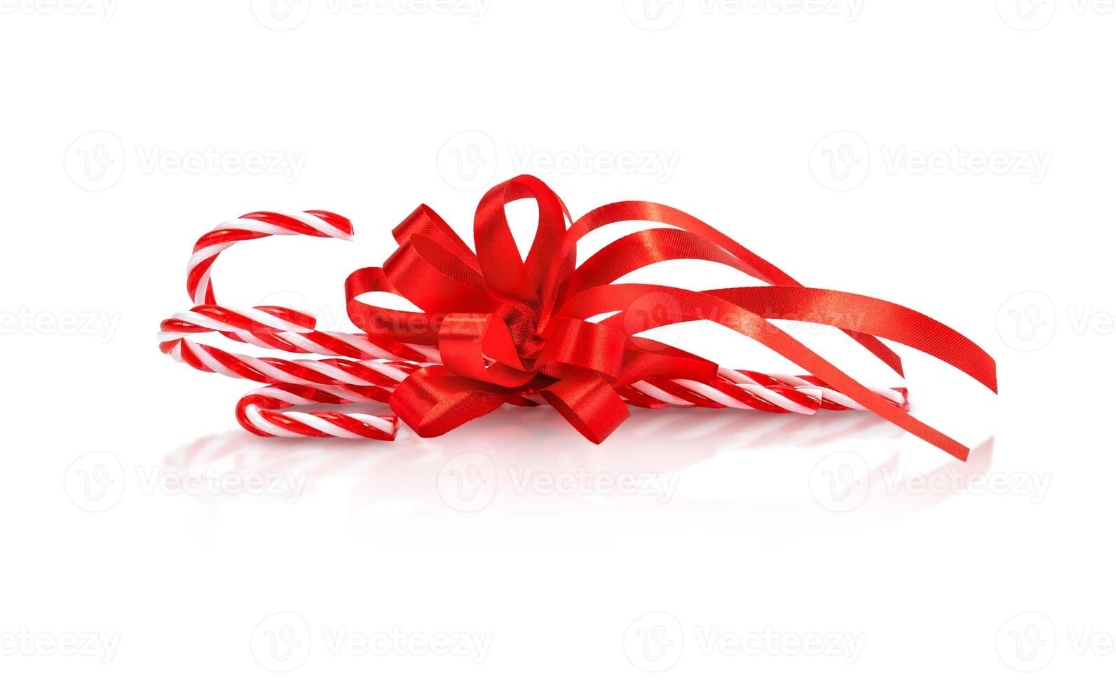 Christmas candy cane with red bow isolated photo