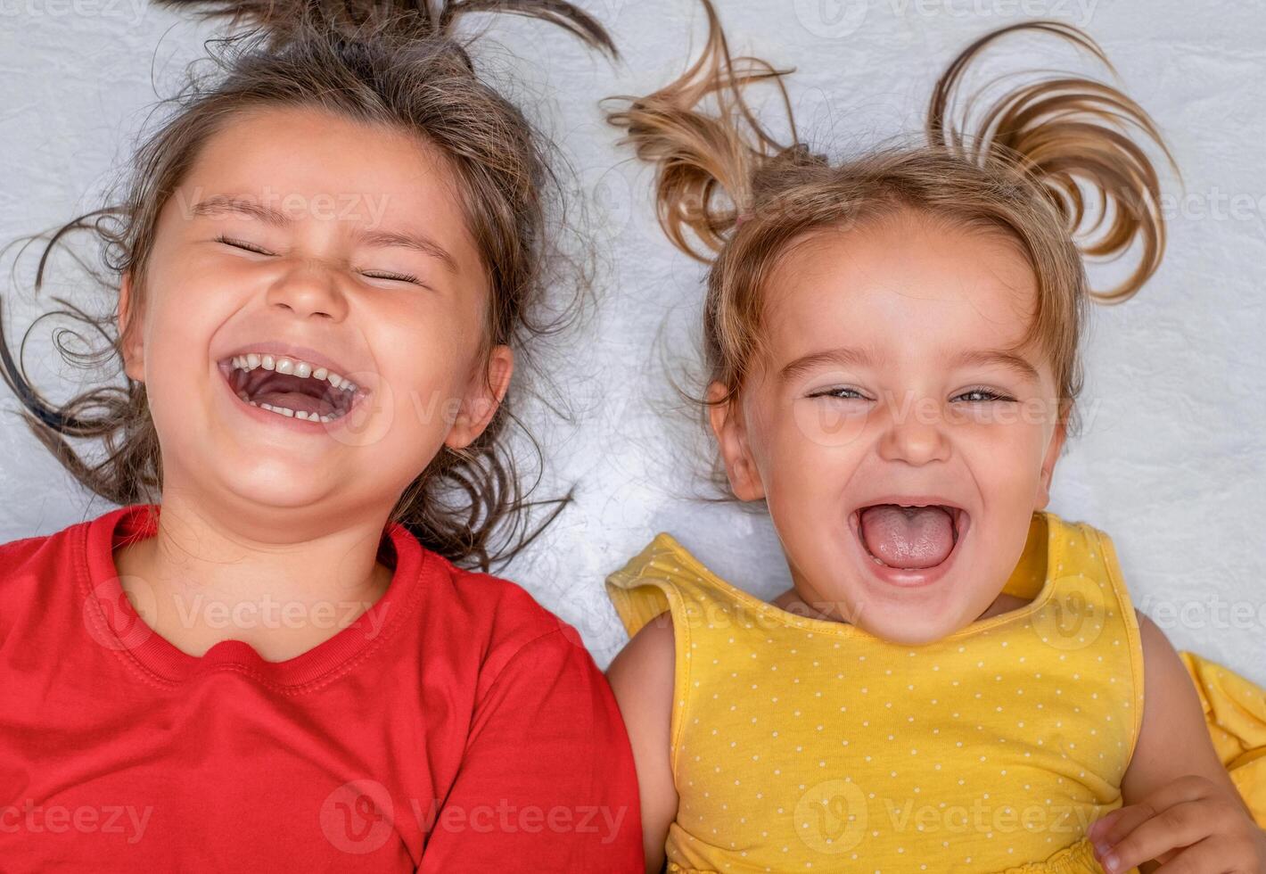 Children lie on the floor and laugh photo