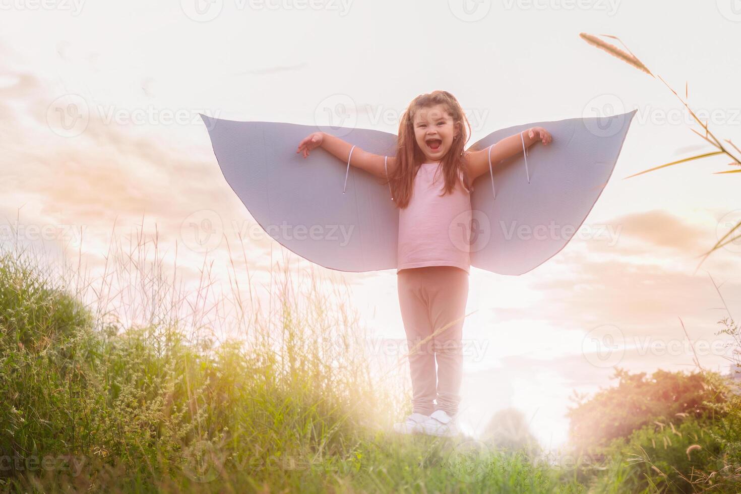 Child girl with wings at sunset photo