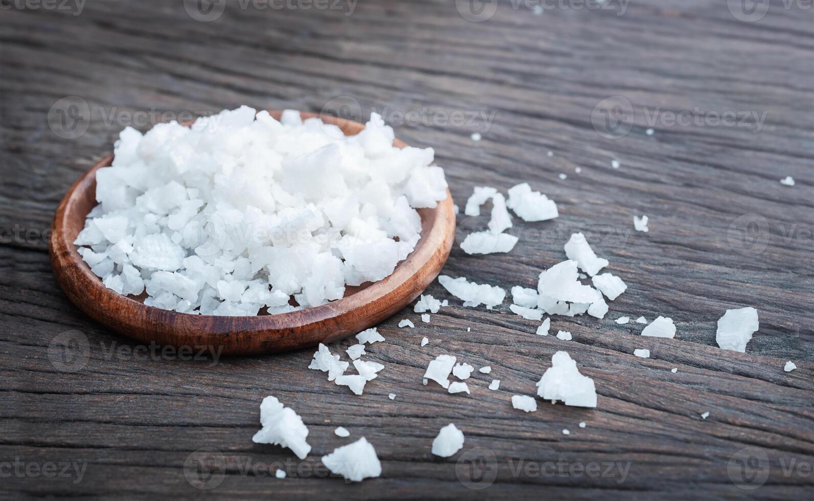 Sea salt on wooden background photo