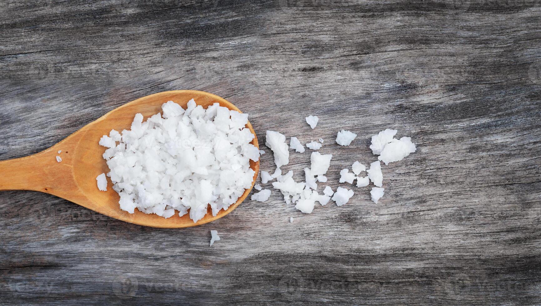 Sea salt in wooden spoon photo