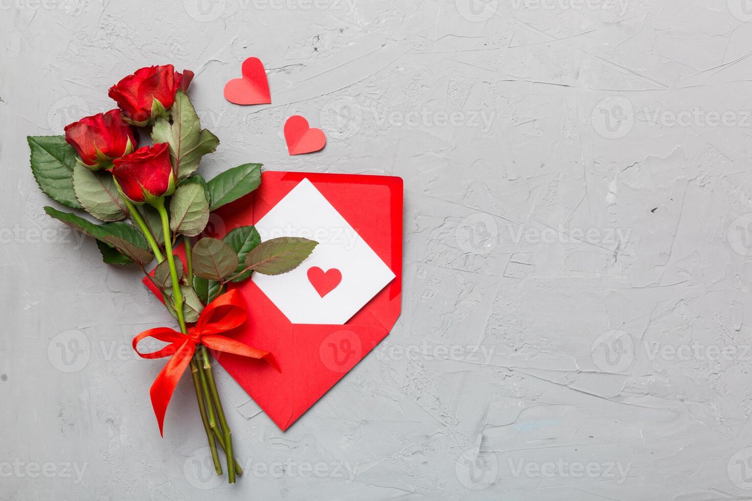 Valentine day composition with Envelope, rose flower and Red heart on table. Top view, flat lay. Holiday concept photo