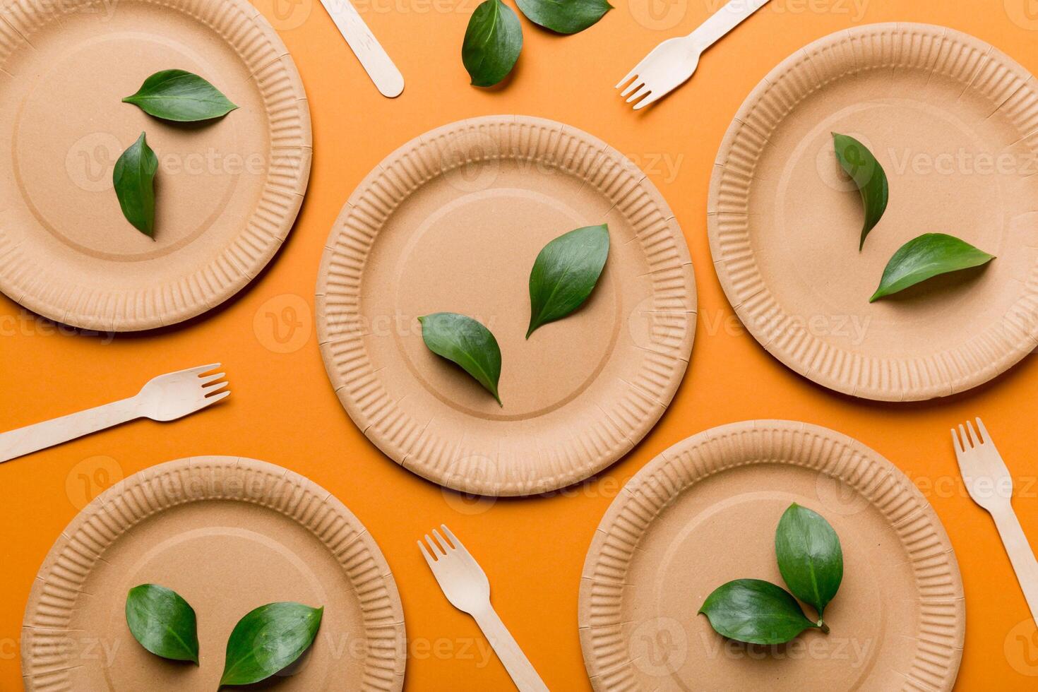 set of empty reusable disposable eco-friendly plates, cups, utensils on light white colored table background. top view. Biodegradable craft dishes. Recycling concept. Close-up photo