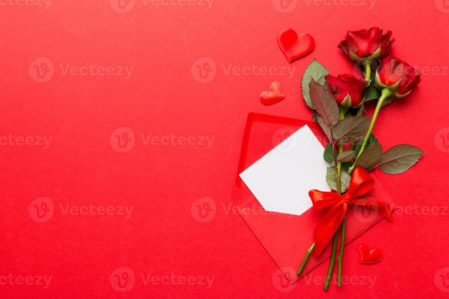 Valentine day composition with Envelope, rose flower and Red heart on table. Top view, flat lay. Holiday concept photo