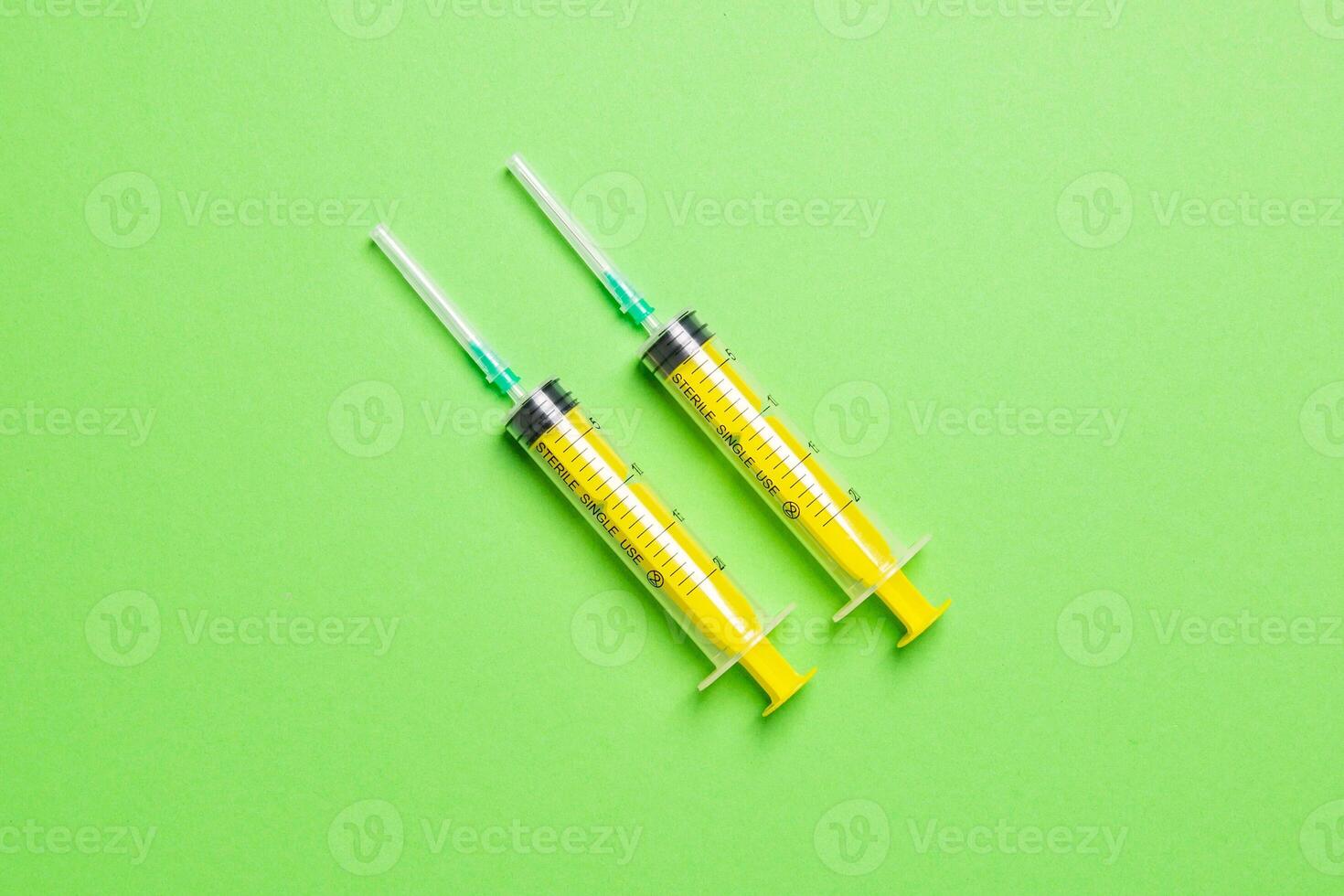 Top view of different syringes for injection on colorful background. Medical equipment concept with copy space photo