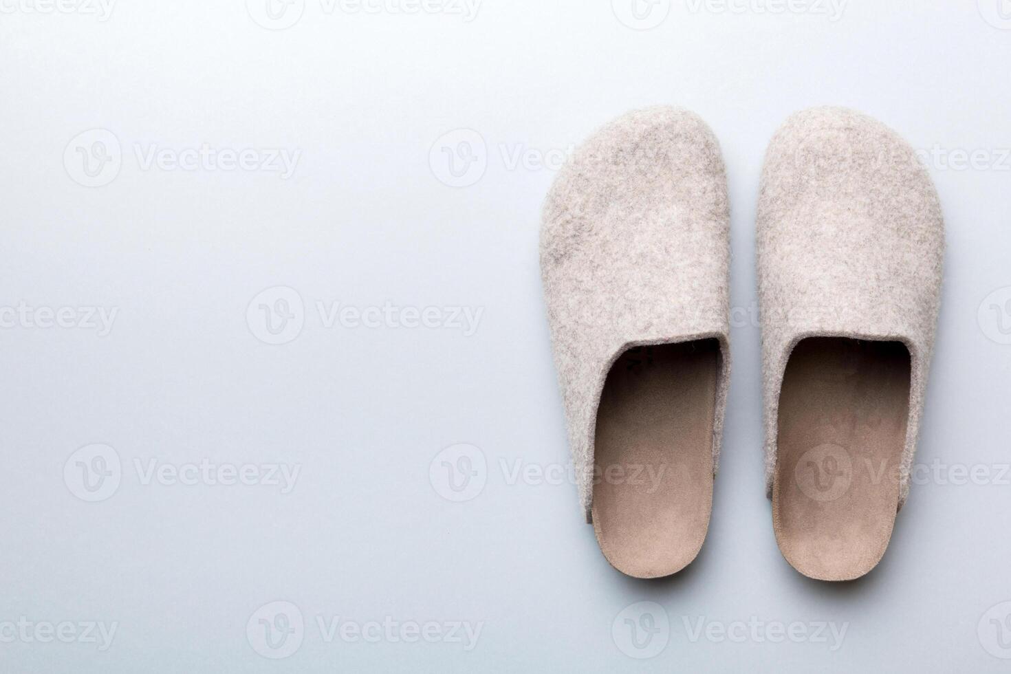 Warm winter women woolen slippers on colored background. Copy space for text photo