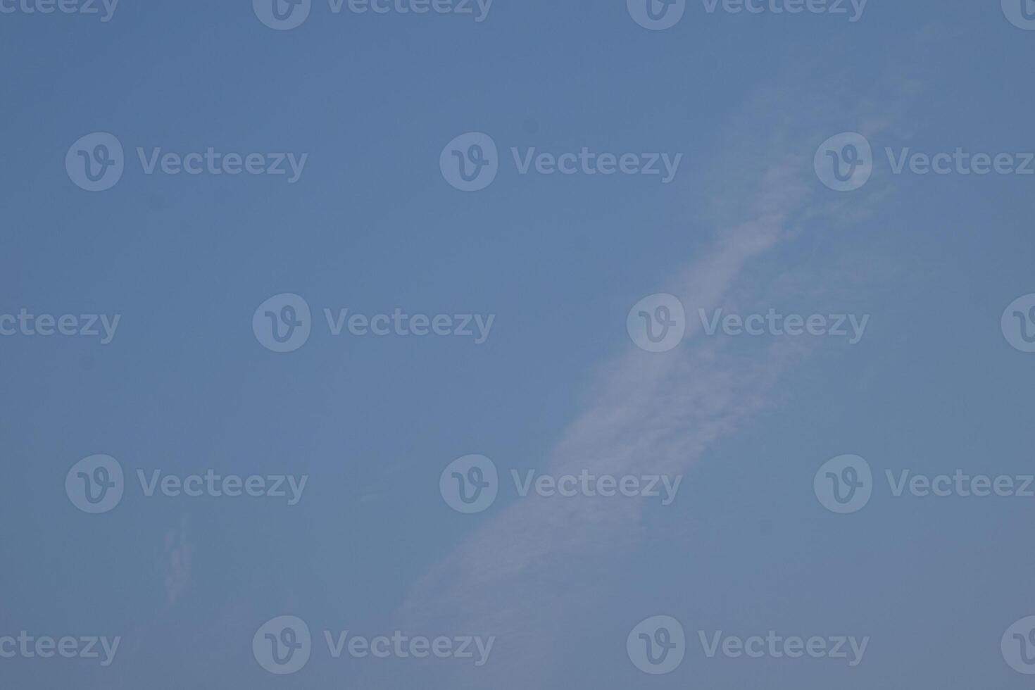 a clear blue sky with some clouds in it photo