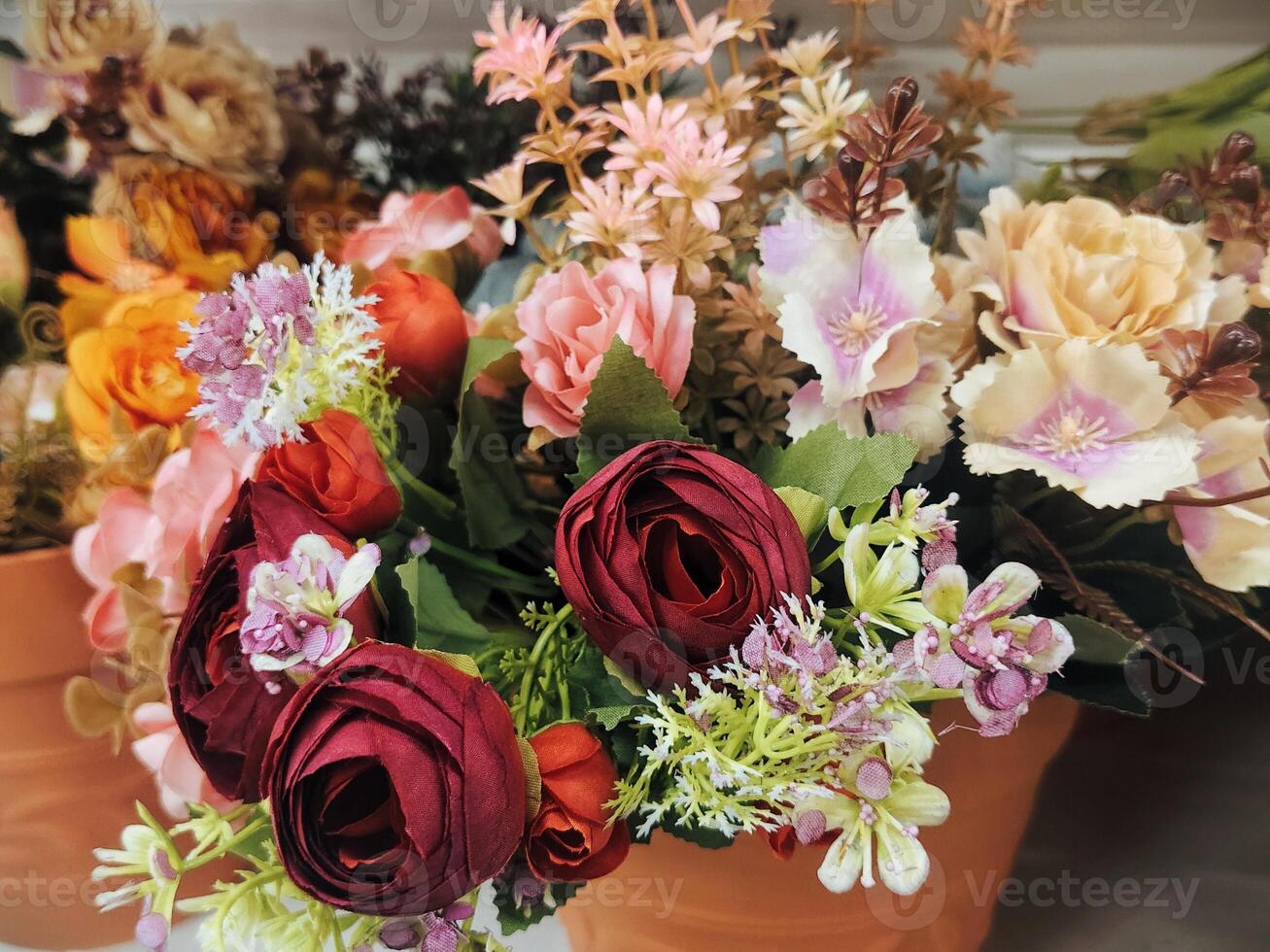 Beautiful Assorted Artificial Flowers in Vibrant Colors Arranged in a Floral Display photo