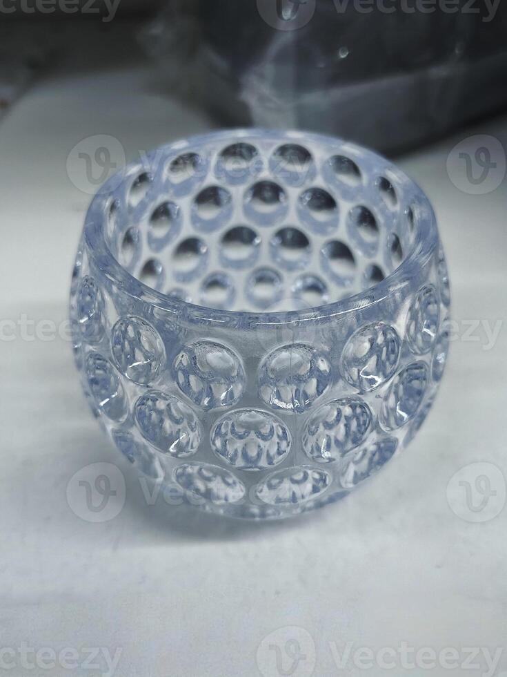 A clear glass container with a unique bubble pattern, ideal for decorative or functional use in modern spaces photo