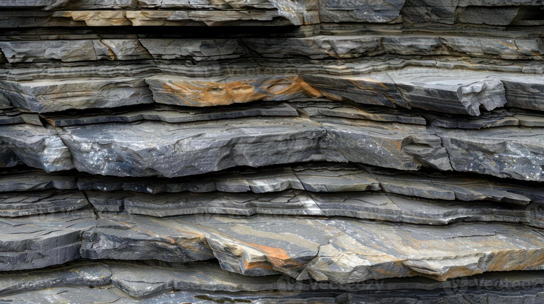 Closeup of layered rock formation with a rough texture and an uneven surface. photo