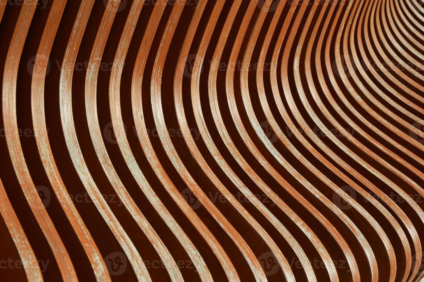 Brown wooden planks, fragment of a bench with curved geometry, vertical planks. Abstract background. photo