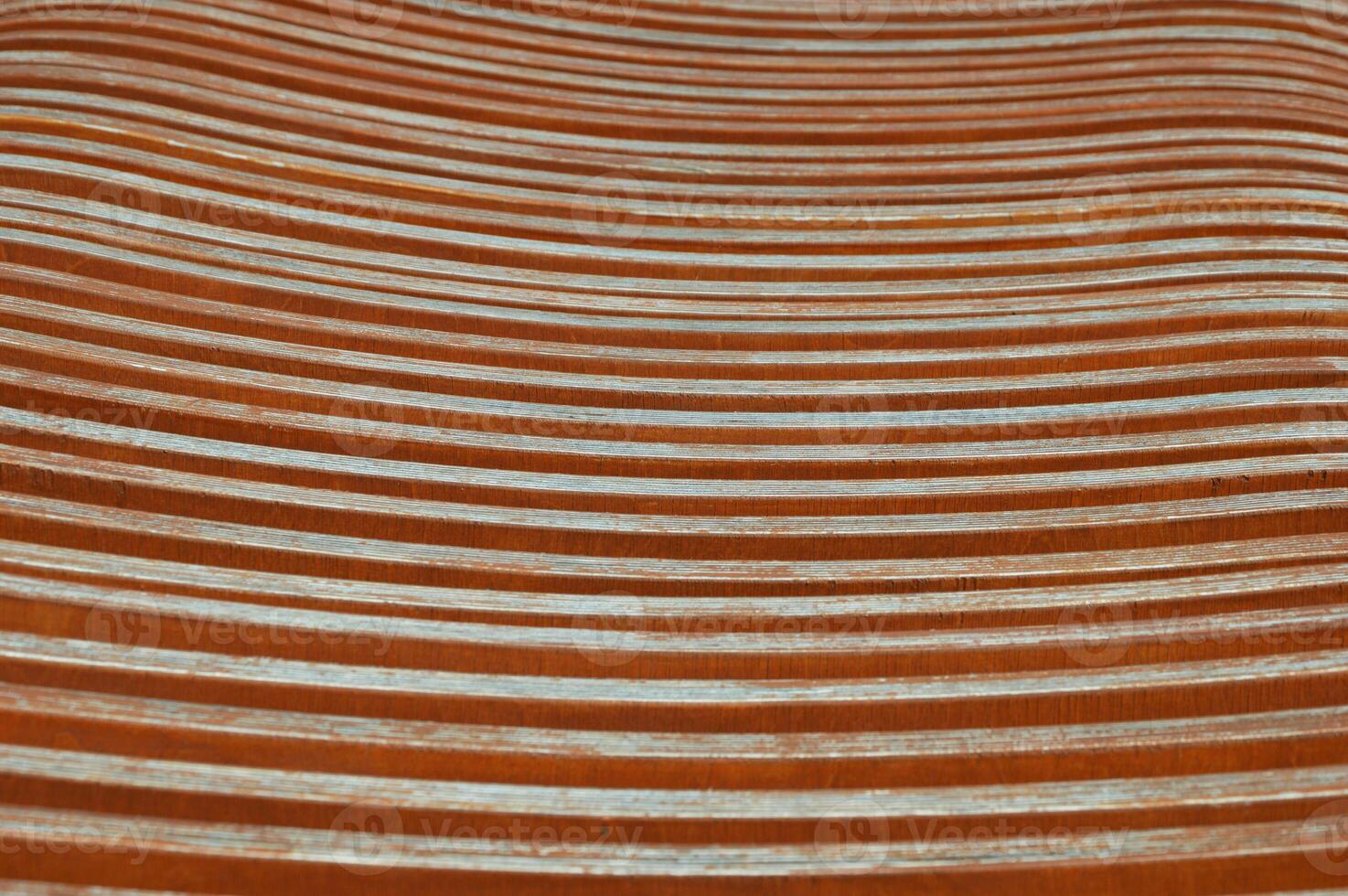 Brown wooden planks, fragment of a bench with curved geometry, horizontal planks. Abstract background. photo