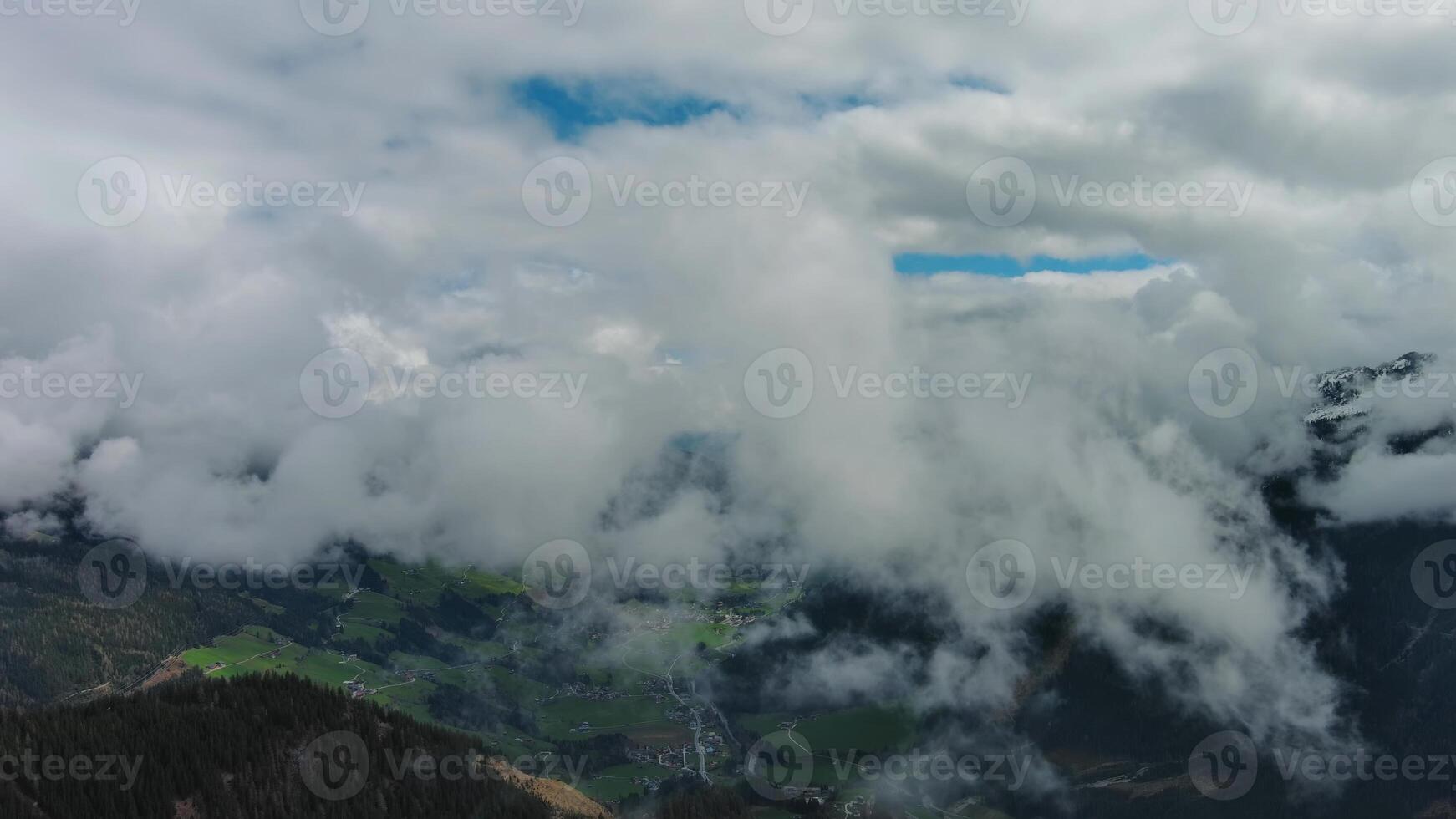 Aerial view of snowcapped mountains in clouds photo