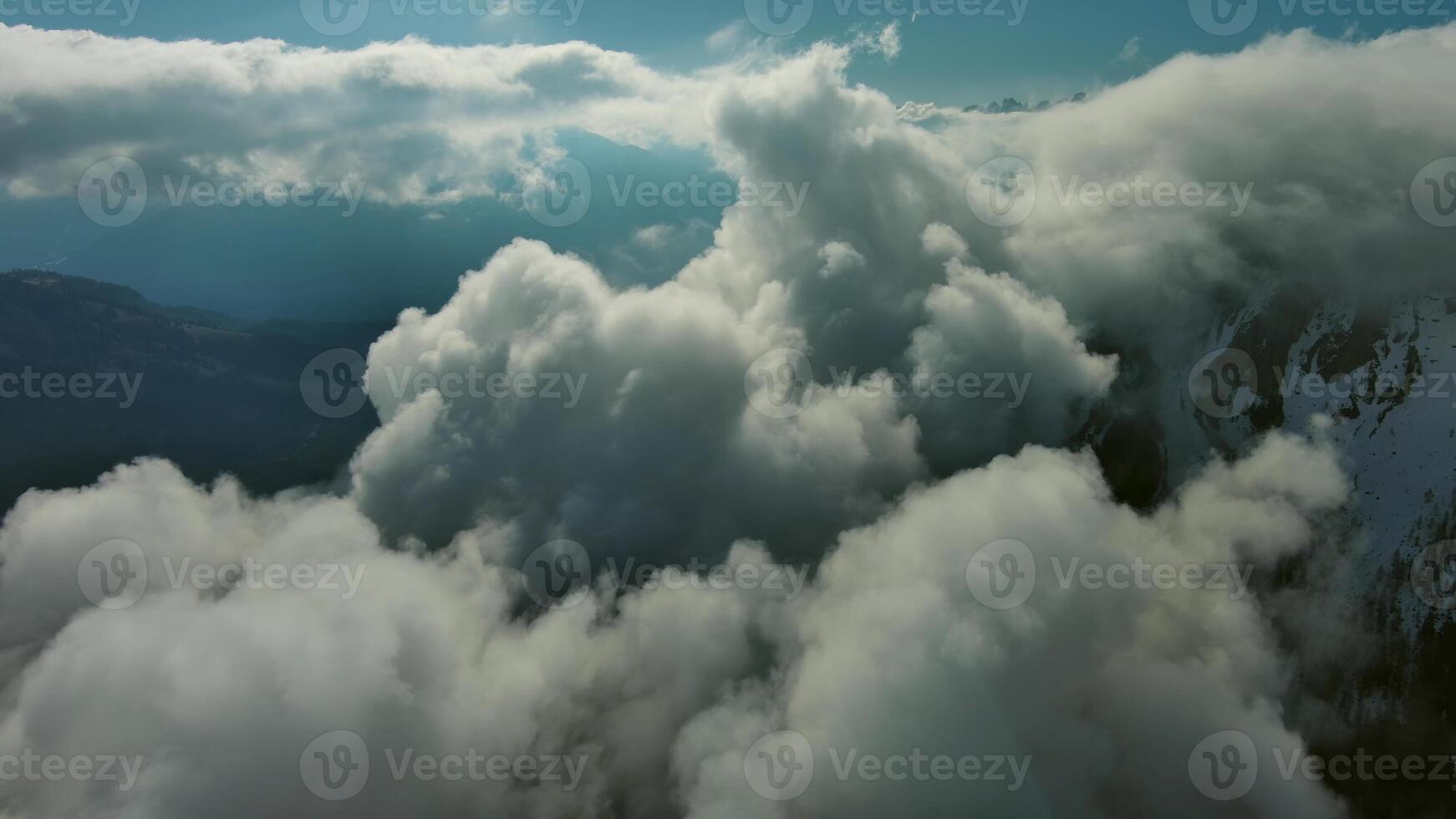 Flying through clouds between mountains photo
