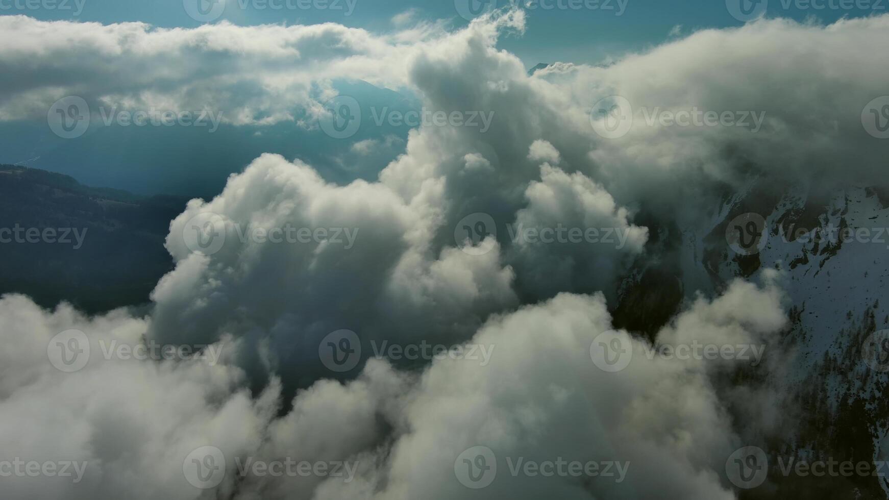Flying through clouds between mountains photo