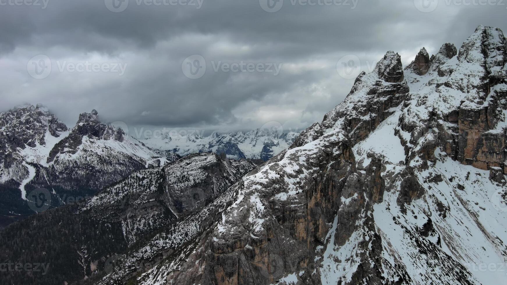 Rocky snow mountains and clouds photo