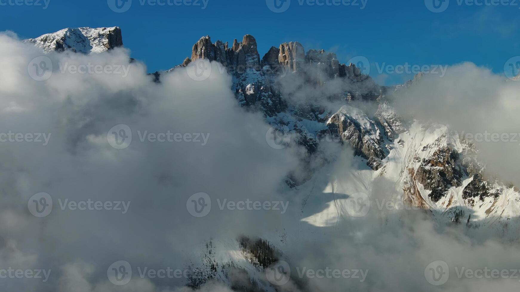 Flying through clouds between mountains photo
