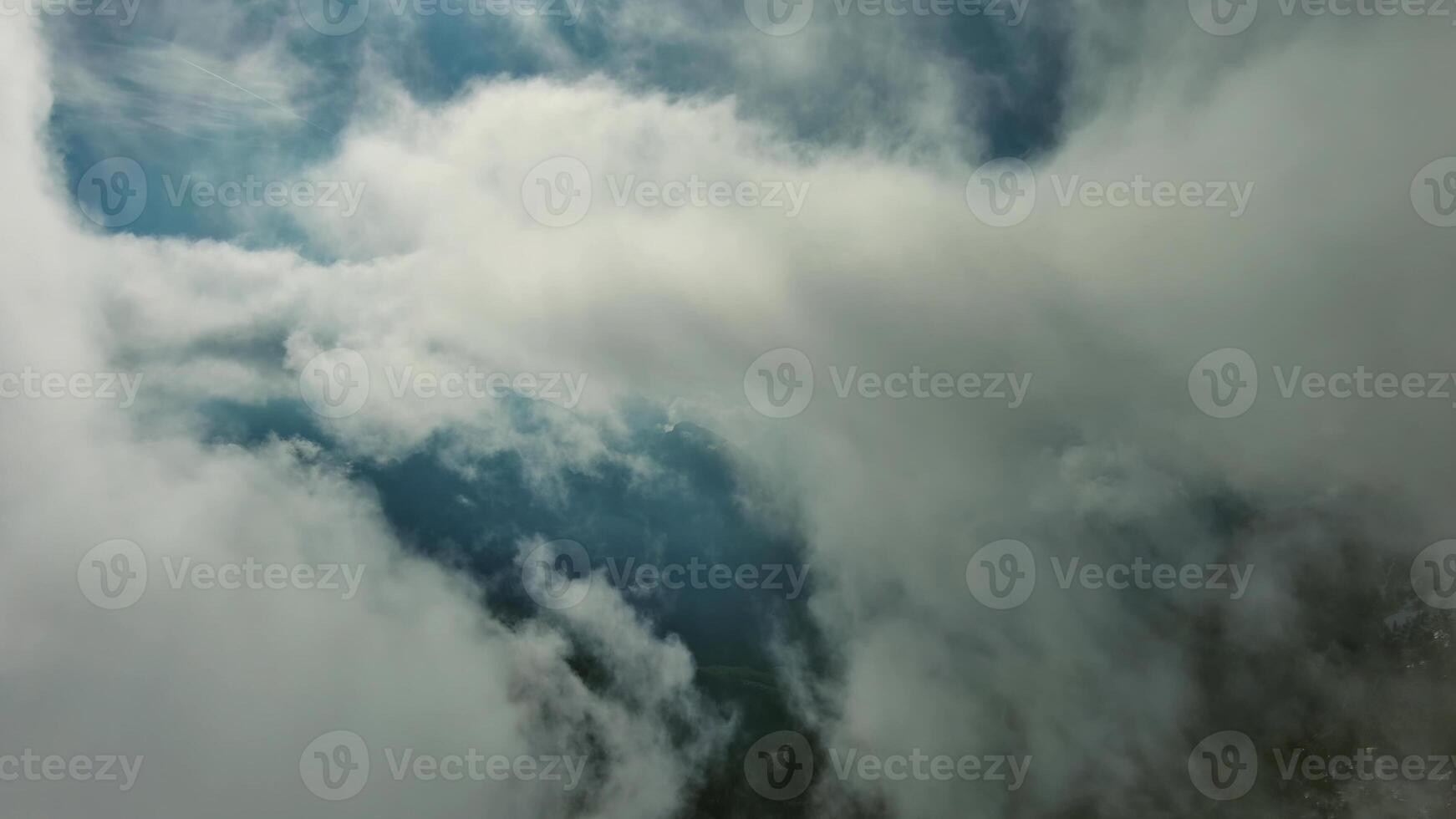 Flying through clouds between mountains photo