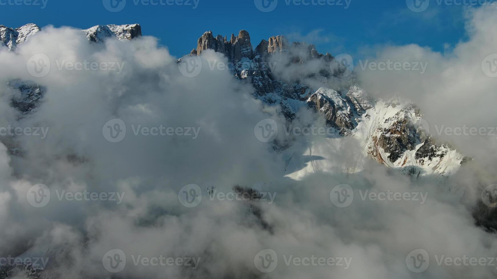 Flying through clouds between mountains photo