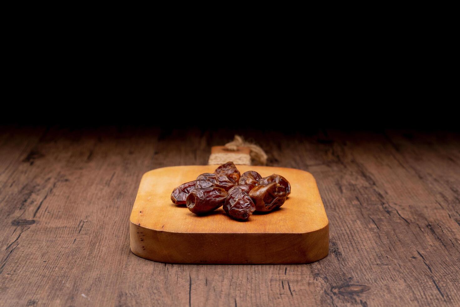 Many Date Palms are on bowls and cups of water and the Quran is on wooden tables, to wait for the time of Iftar, with the concept of ramadan Muslims around the world. photo