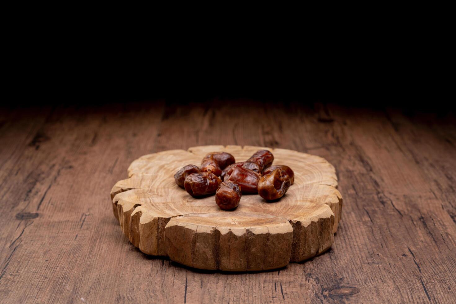 Many Date Palms are on bowls and cups of water and the Quran is on wooden tables, to wait for the time of Iftar, with the concept of ramadan Muslims around the world. photo