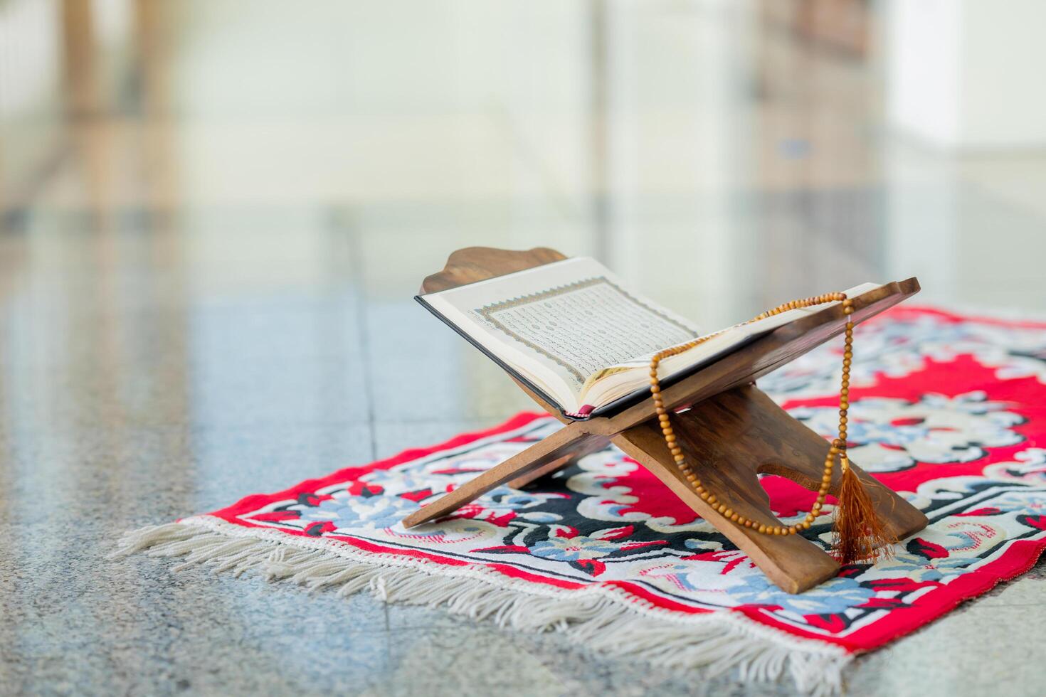 Islamic concept - The Holy Al Quran with written Arabic calligraphy meaning of Al Quran and rosary beads or tasbih photo