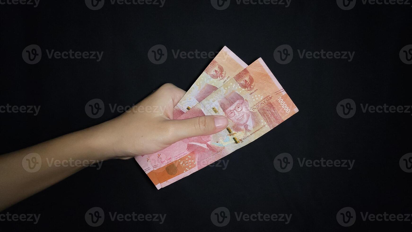 Hand holding several money.Isolated on black background photo