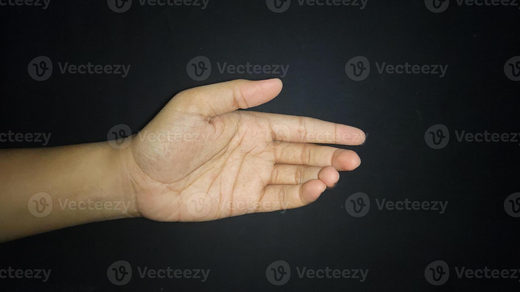 Hands show a gesture of giving help. Isolated on black background photo