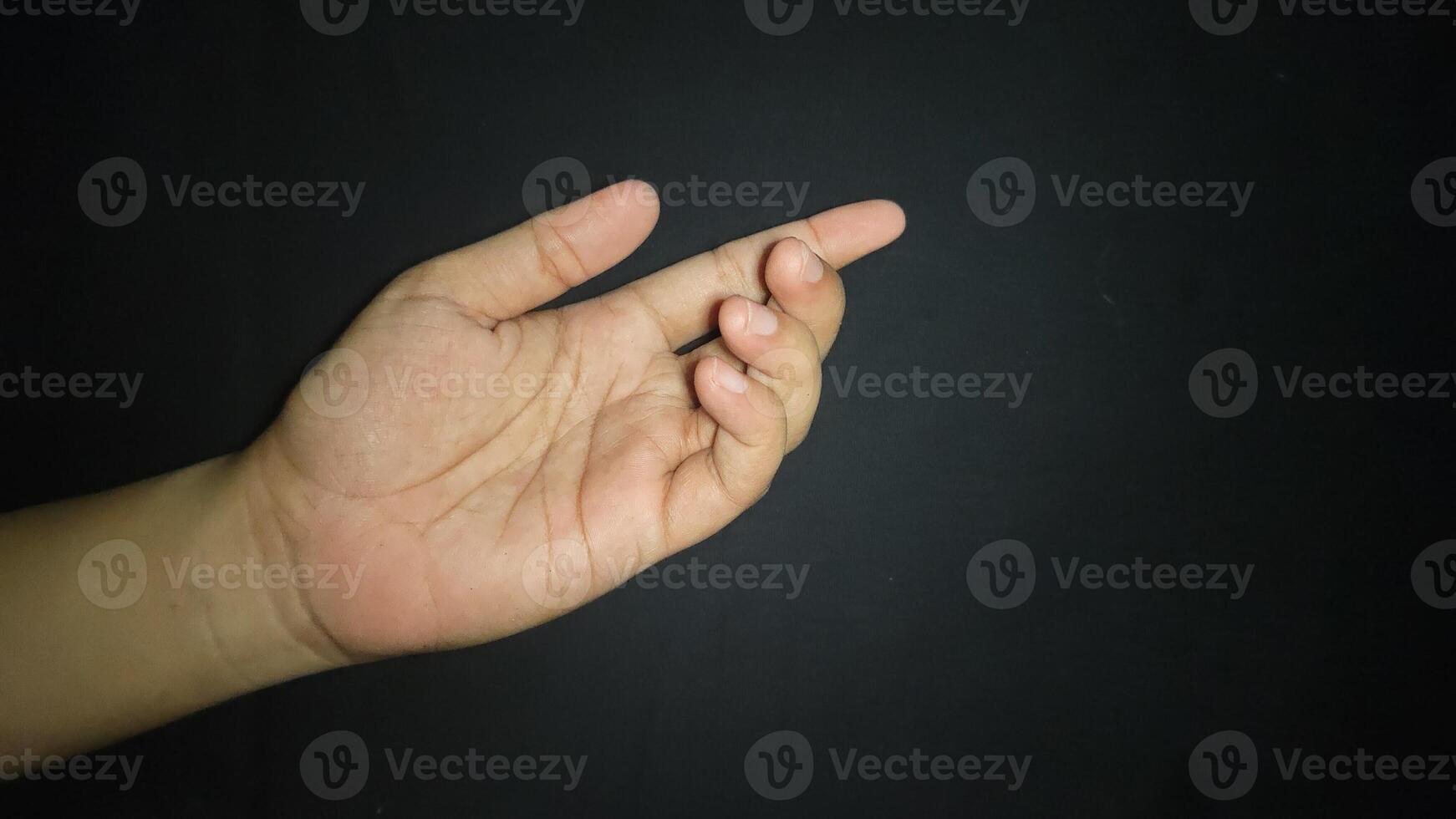 Hands with a gesture asking for help. Isolated on black background photo