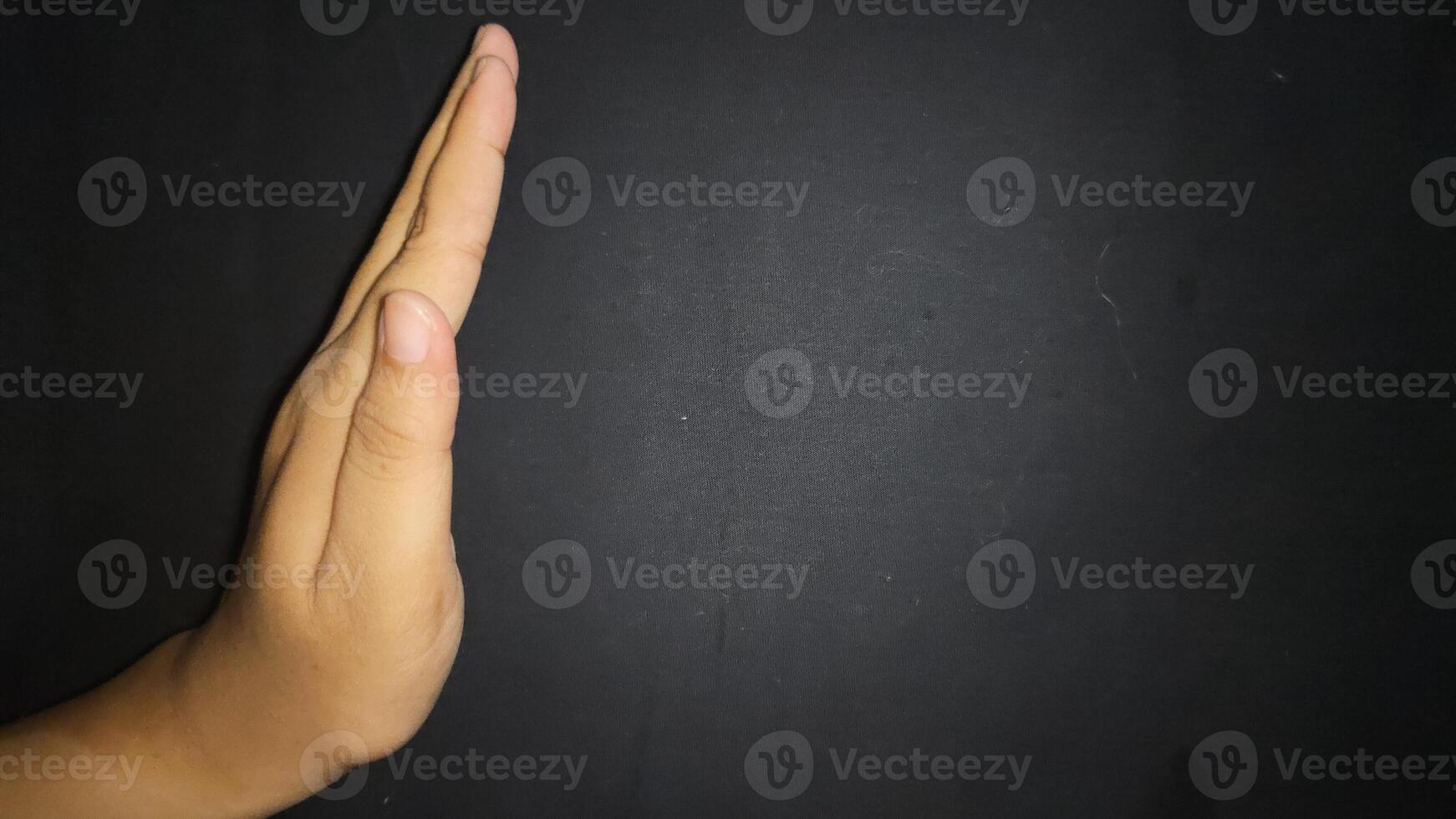 Hand by showing a stop or warning gesture.Isolated on black background photo