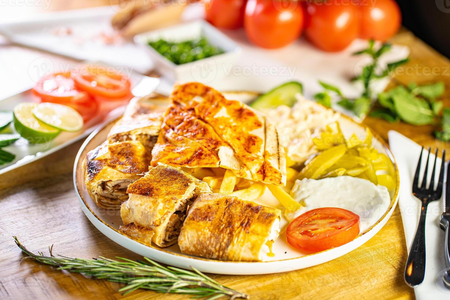 Chicken roll breast stuffed with butter, garlic and dill. Served with baked potato slices and fresh herbs. photo