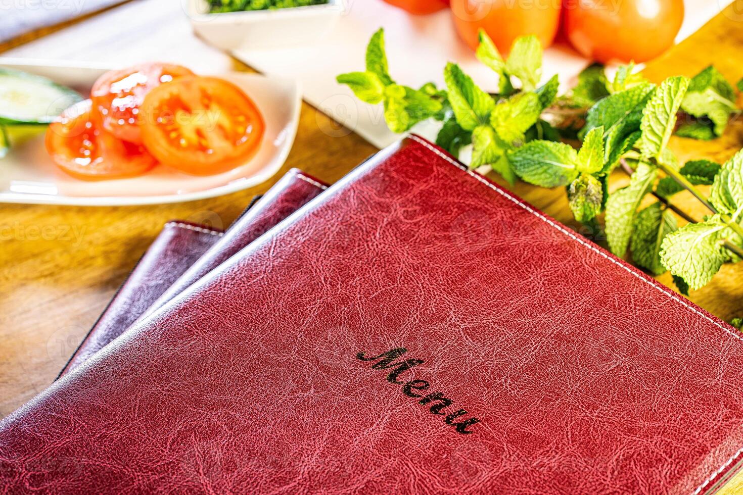 Menu restaurant fresh tomatoes with mint and basil on wooden table over bokeh background photo