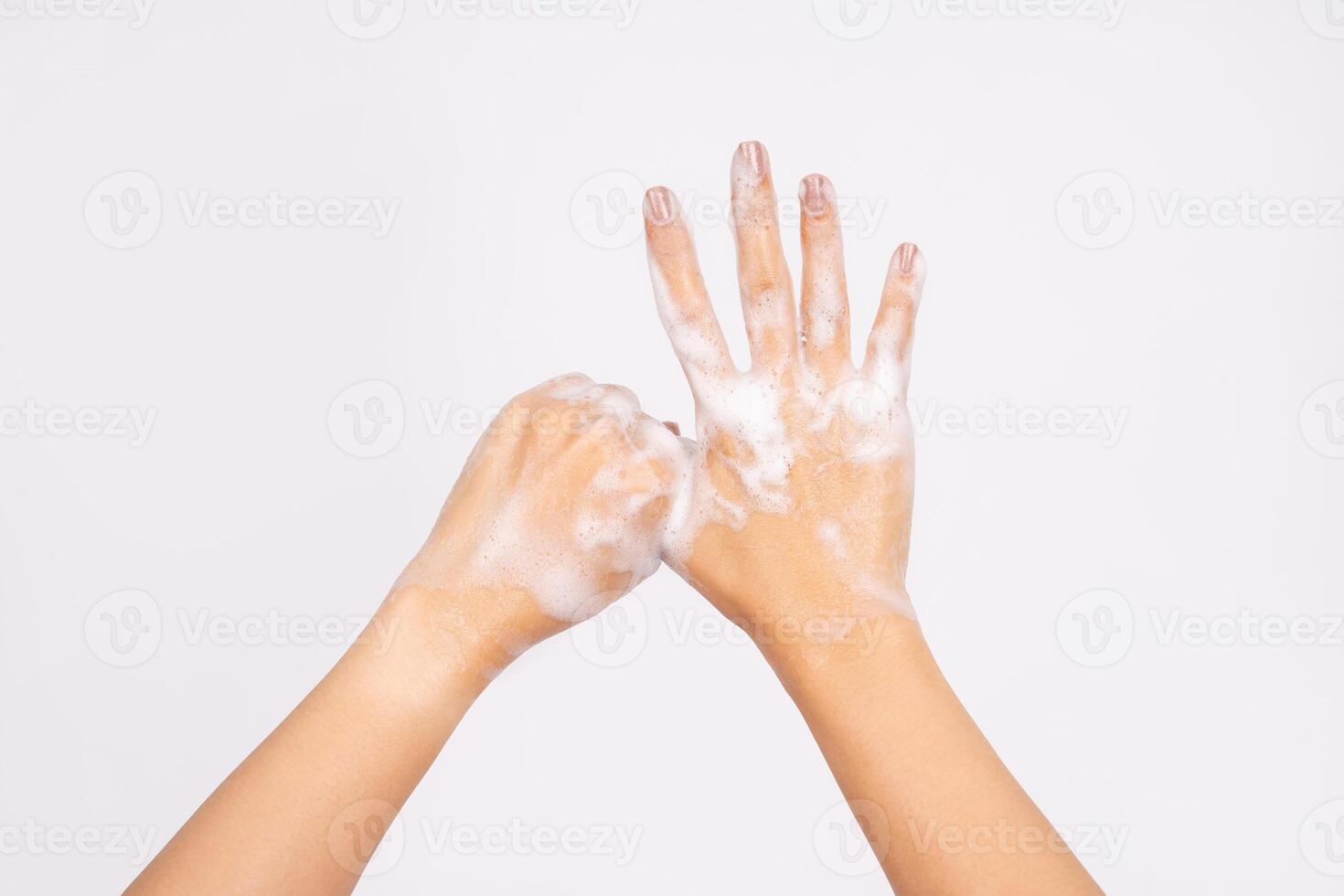 Woman using hand sanitizer to prevent spread of virus or bacteria isolated on white background photo
