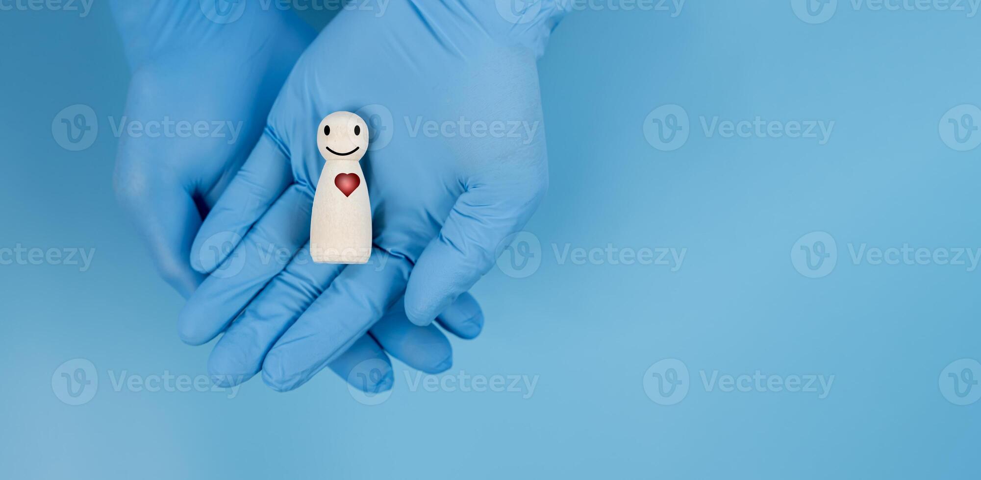 Doctor hand holding wooden block with smiling face and heartbeat icon photo