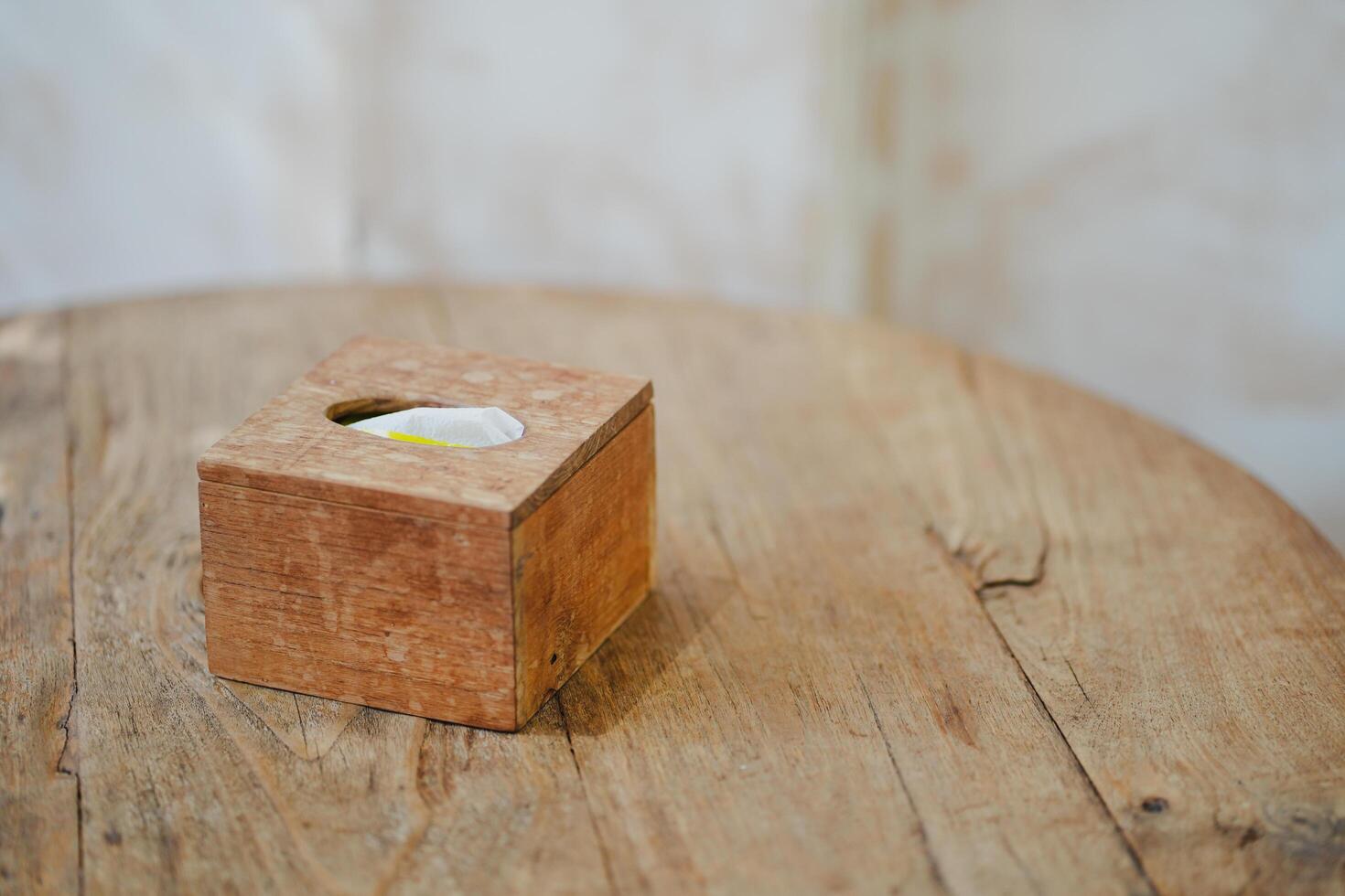 Close up and selective focus tissue paper in wood box on wooden table in kitchen or dining room. photo