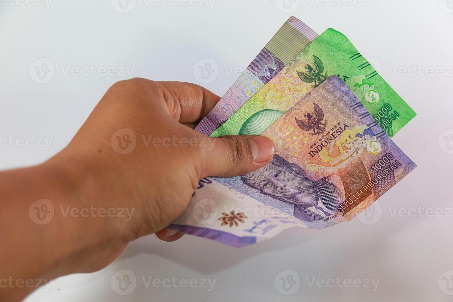 hand holding money, hand giving money as a method of payment isolated on white photo