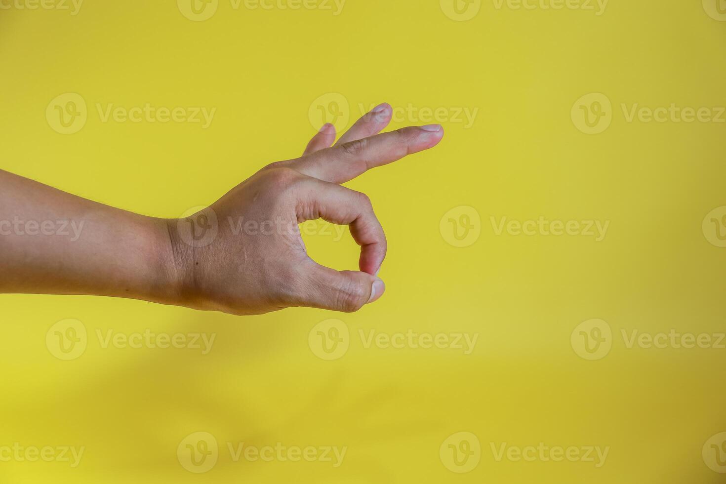 human hand gesturing approval expression doing okay symbol with fingers photo