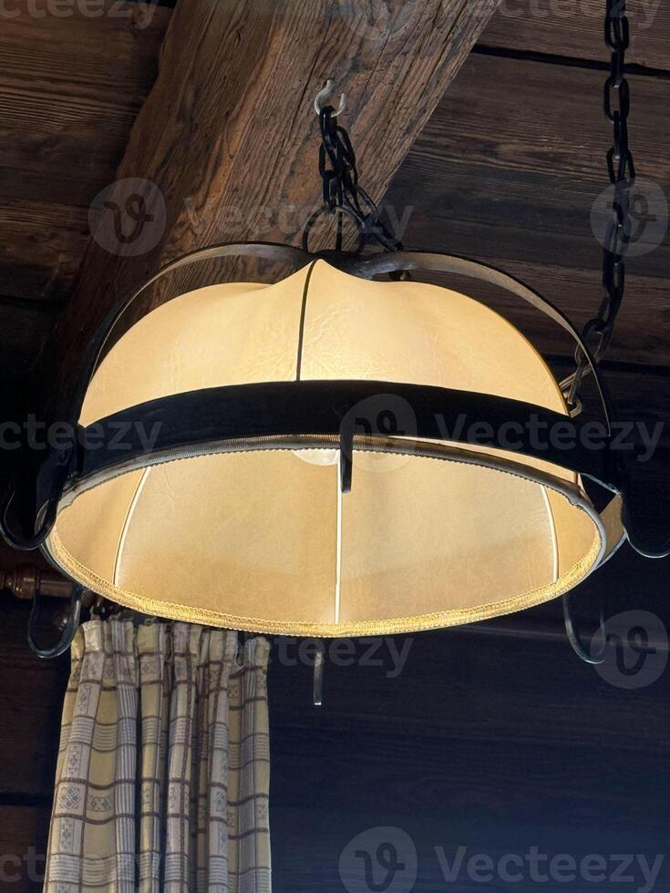Rustic indoor ceiling light fixture with wooden beam support photo