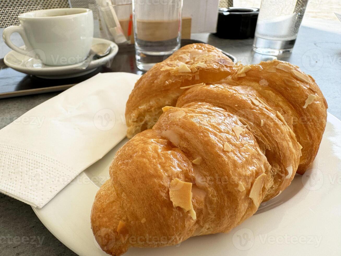 Fresh croissant breakfast with coffee at a cozy cafe photo