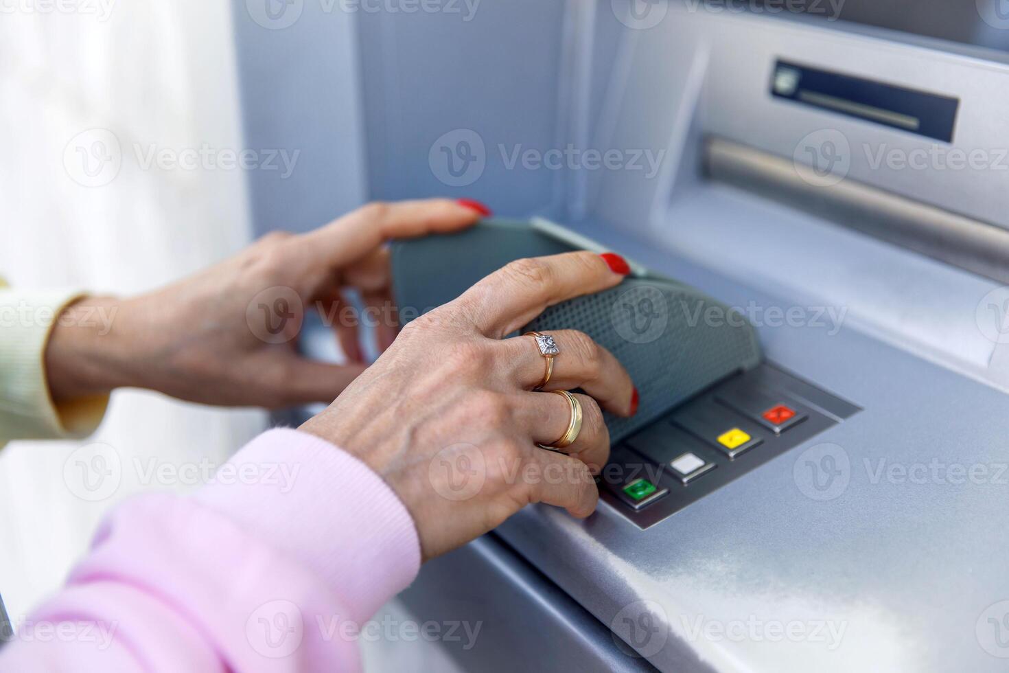 Close-up of hands entering pin at atm secure personal banking concept photo