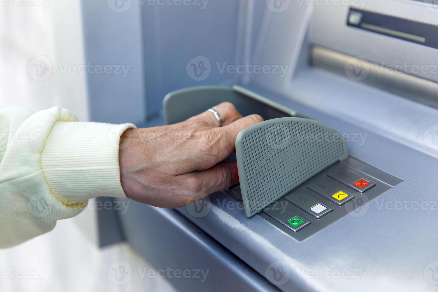 Person using an atm for secure banking transactions and money withdrawals photo