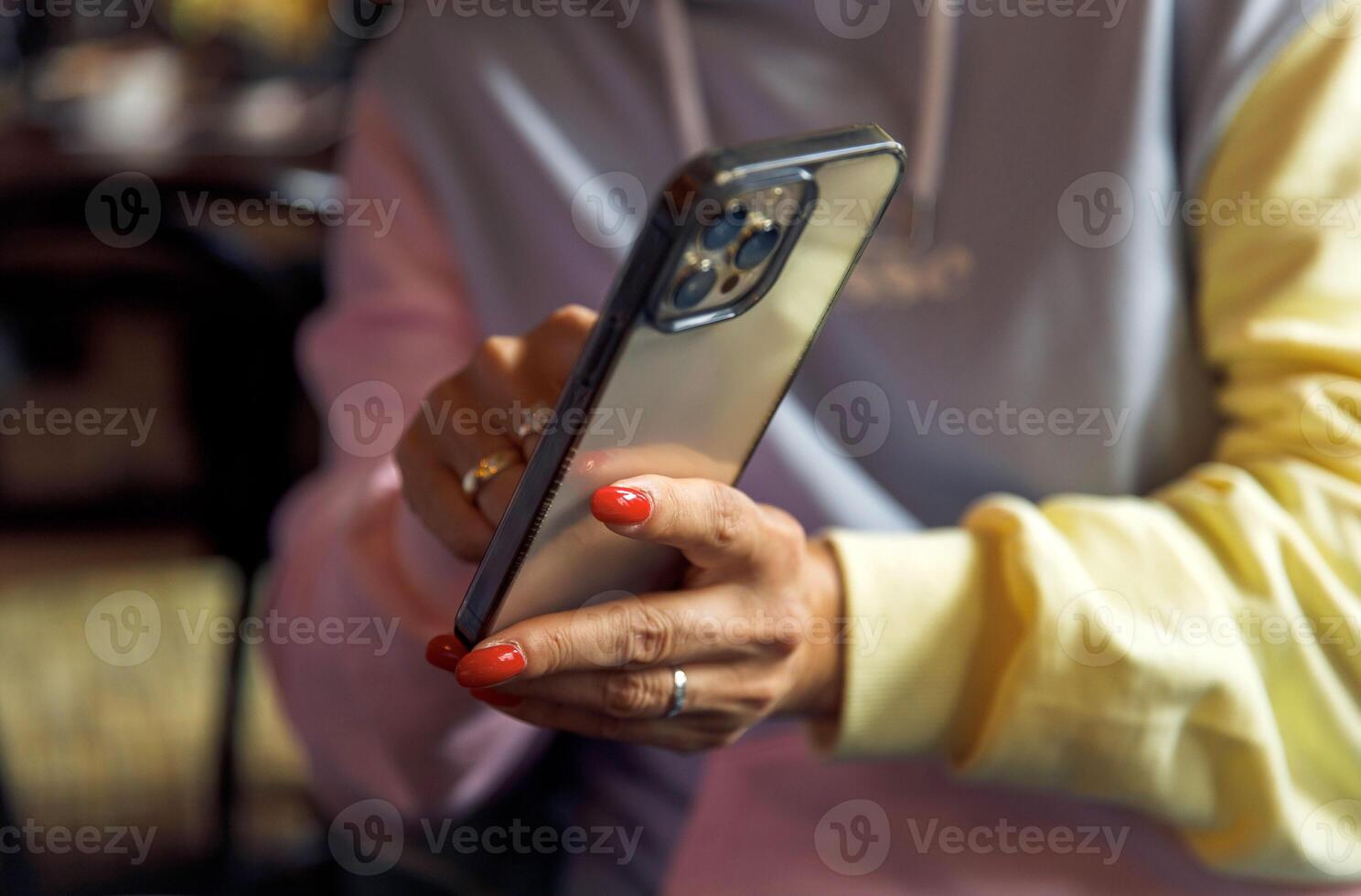 Woman using smartphone with stylish case in casual setting photo