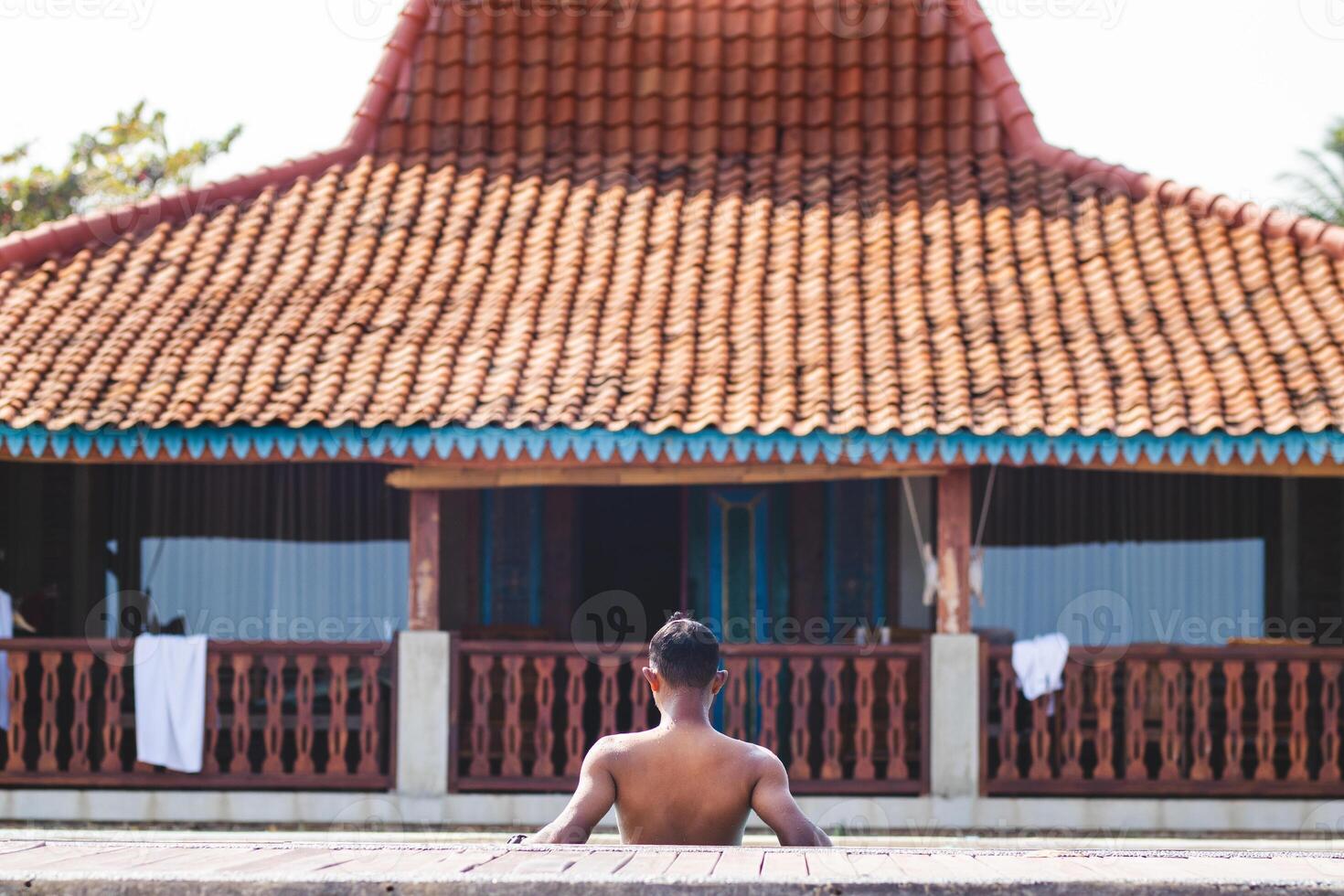 Unidentified man Admiring Scenic Villa View from Behind. Timeless Beauty of a Rustic Traditional Villa. photo